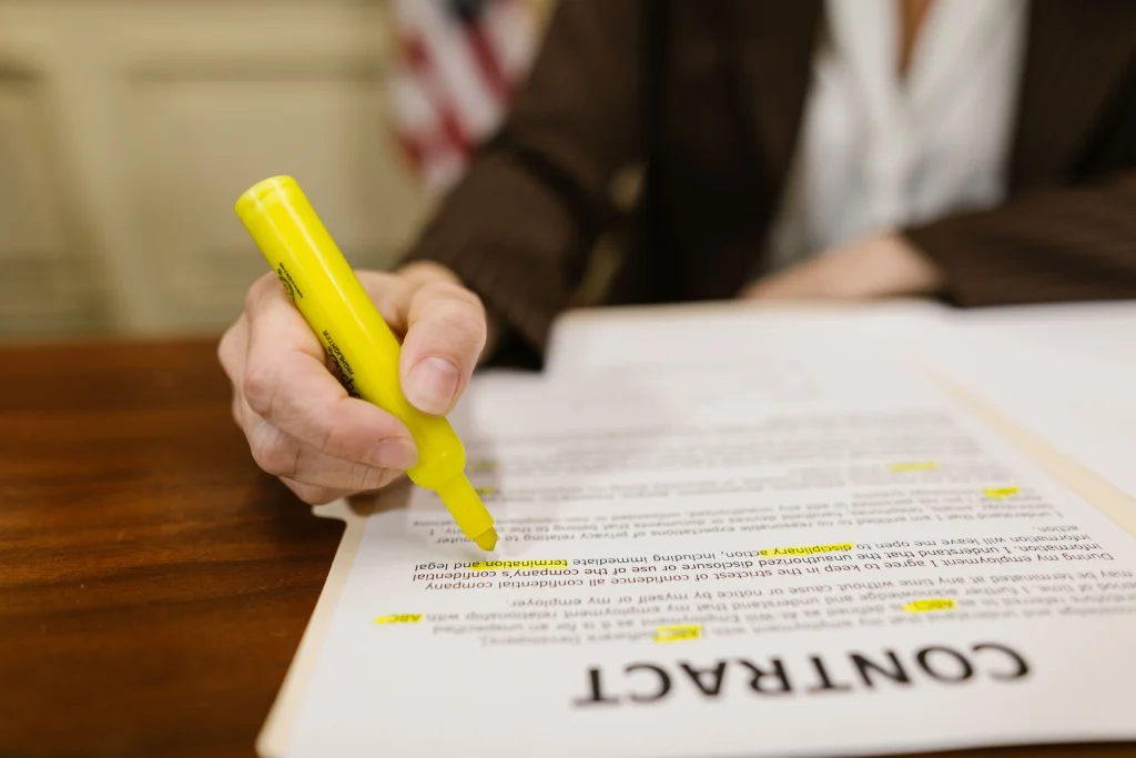 Someone highlighting parts of a contract