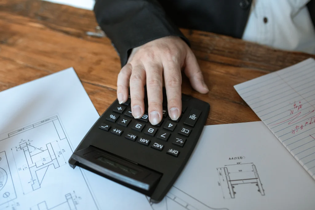 Calculator with fingers on it