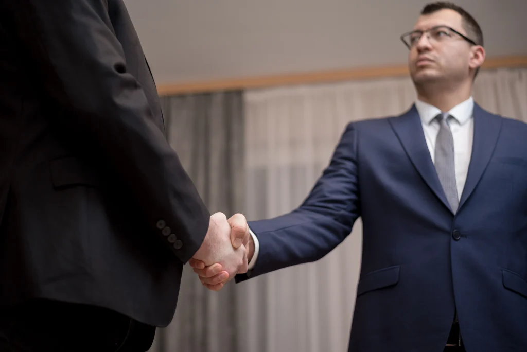 2 men in suits shaking hands