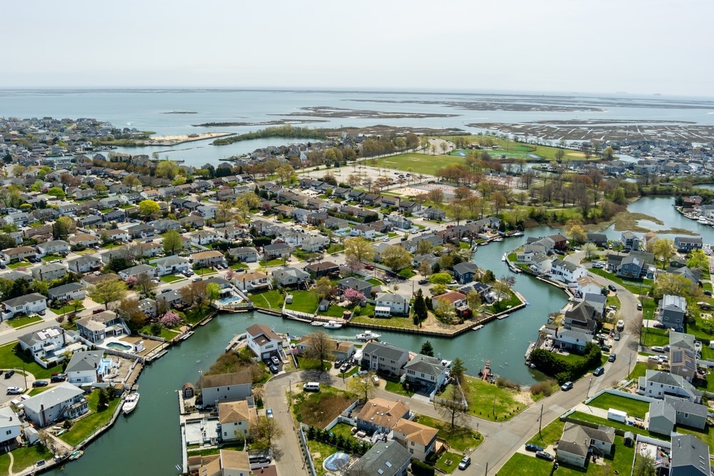 Aerial photo of Nassau County, NY waterfront homes and canals, highlighting family-friendly Long Island neighborhoods ideal for new construction buyers.