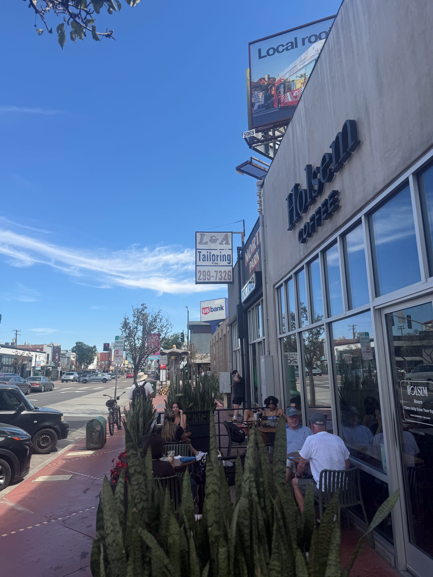 Holsem Coffee sidewalk patio with customers on University Avenue in North Park San Diego
