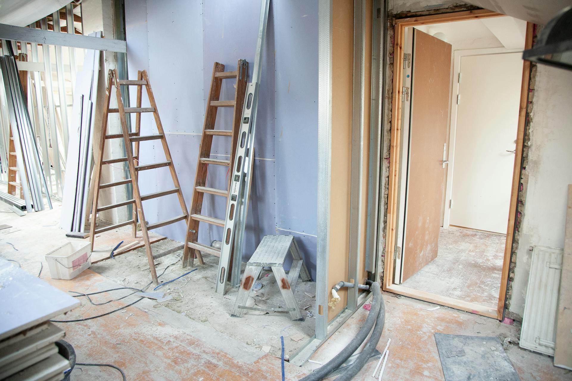 Interior of a home undergoing renovation with exposed walls and construction materials
