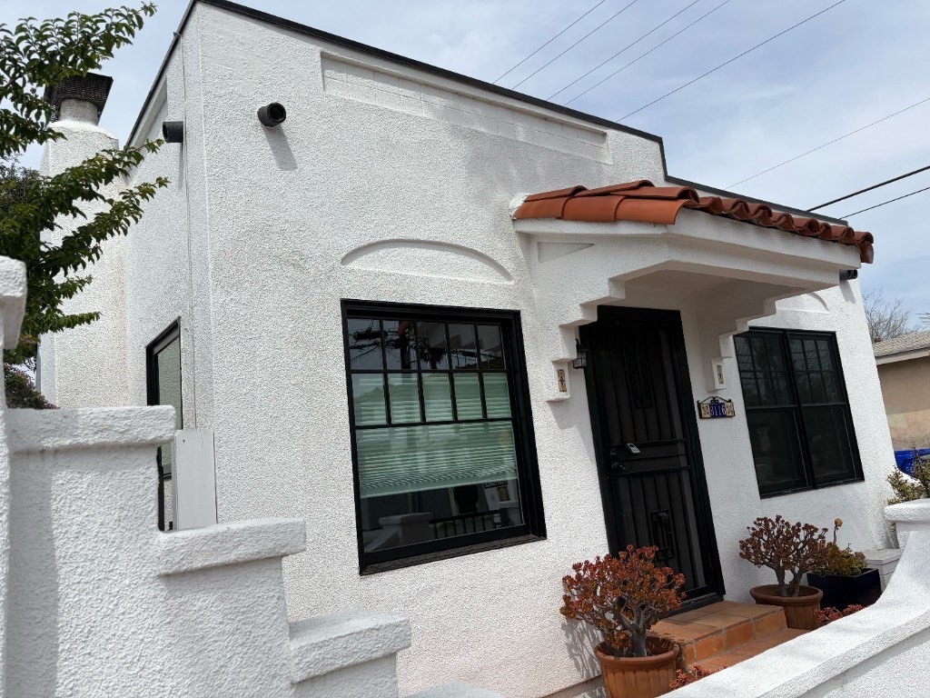 Spanish-style bungalow home in San Diego with white stucco exterior and terra cotta roof