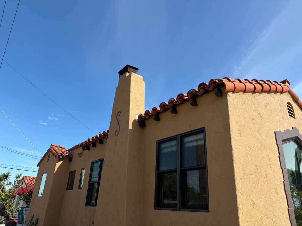 Golden-toned Spanish-style home with barrel tile roof, typical San Diego residential architecture