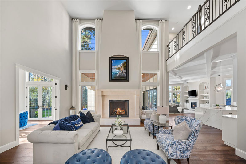 Elegant South Hill home living room featuring a grand two-story ceiling, fireplace, and sophisticated furnishings
