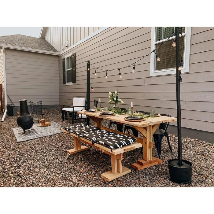 A gravel backyard with a picnic table set up for al fresco dining.