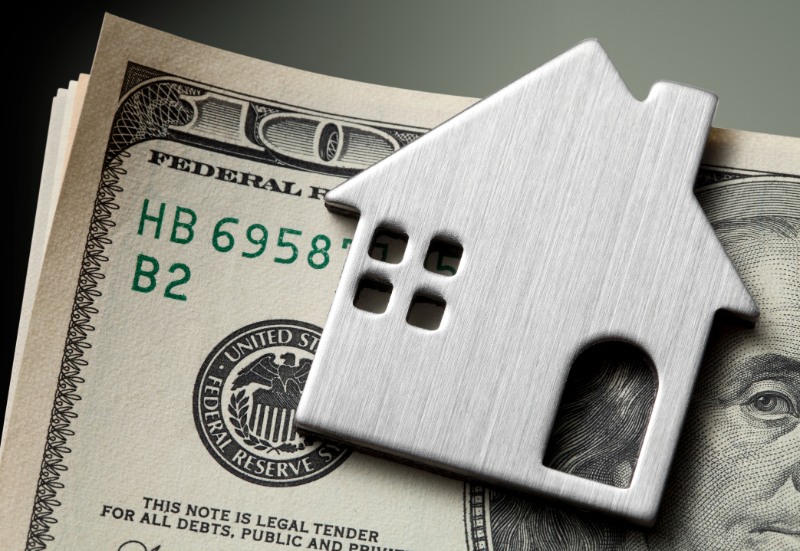Dollar bills with miniature model house