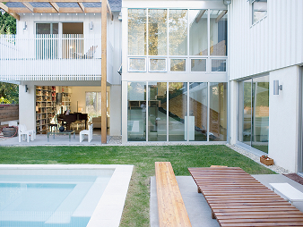 Modern white home exterior with pool and deck