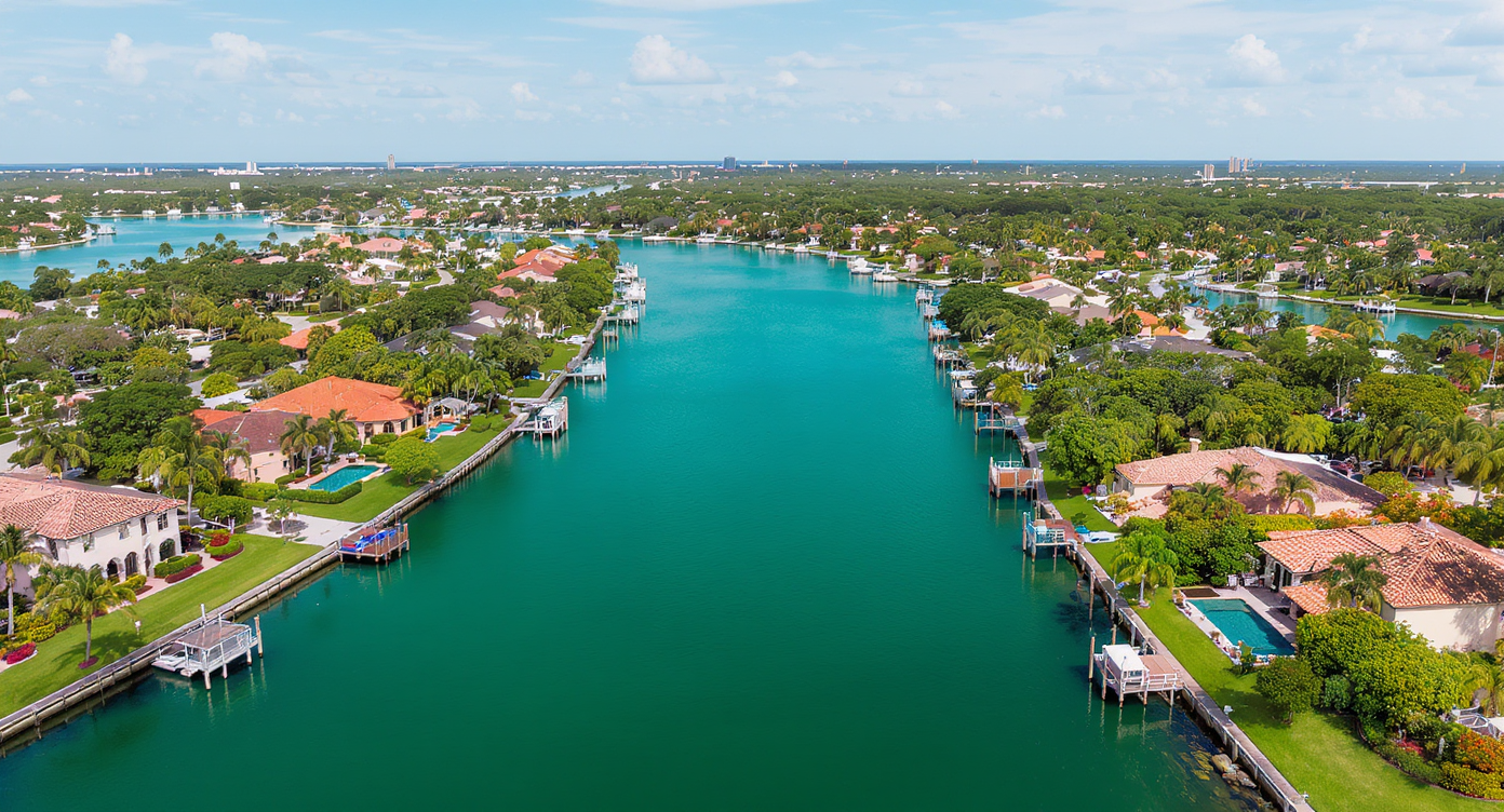 Aerial view of Boca Raton homes along Intracoastal canals showing private docks and turquoise water