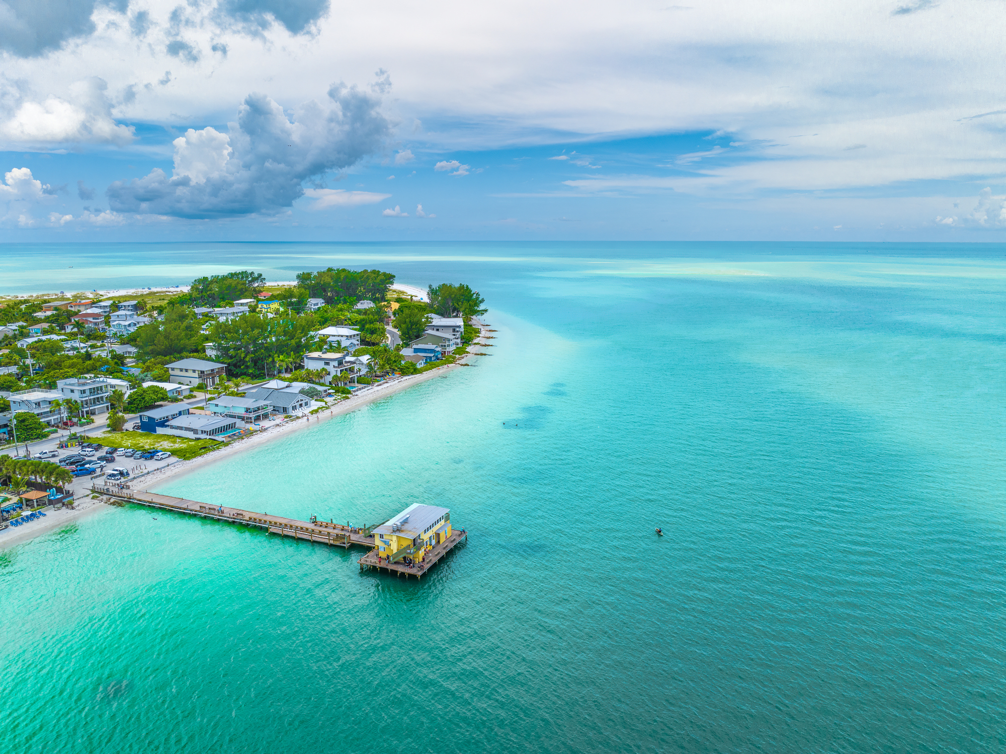 An aerial view of a fishing pier on Holmes Beach in Anna Maria Island Florida.