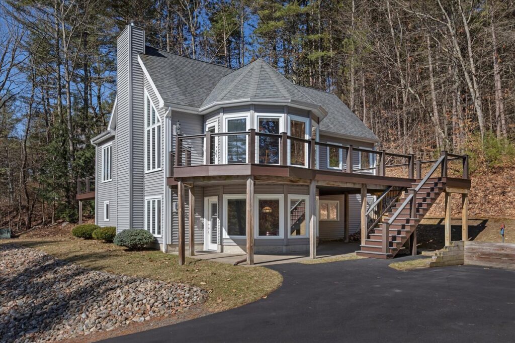 Contemporary home with wraparound deck at Great Sacandaga Lake property in Day NY