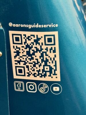 Aaron’s Guide Service QR code and social media information displayed on the fishing boat.