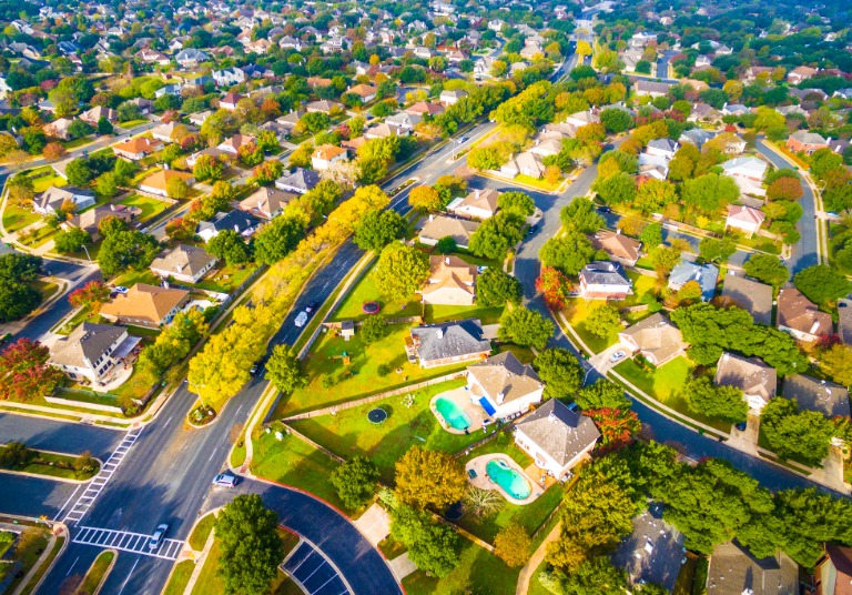 Aerial Over Main Street Down Suburbs
