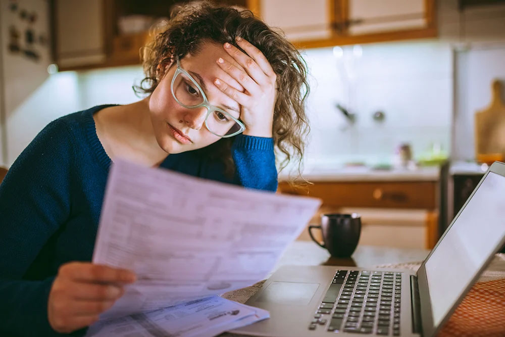 Lady reading and computing monthly bills