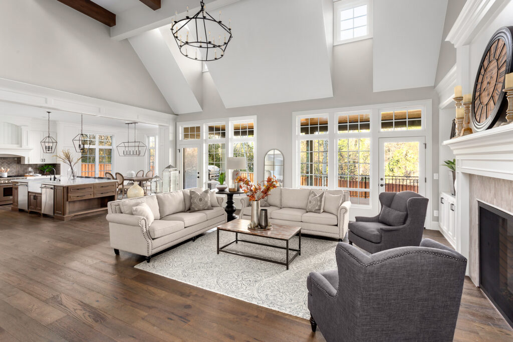 Beautiful living room and kitchen in new traditional style luxury home. Features vaulted ceilings,, and elegant furnishings.