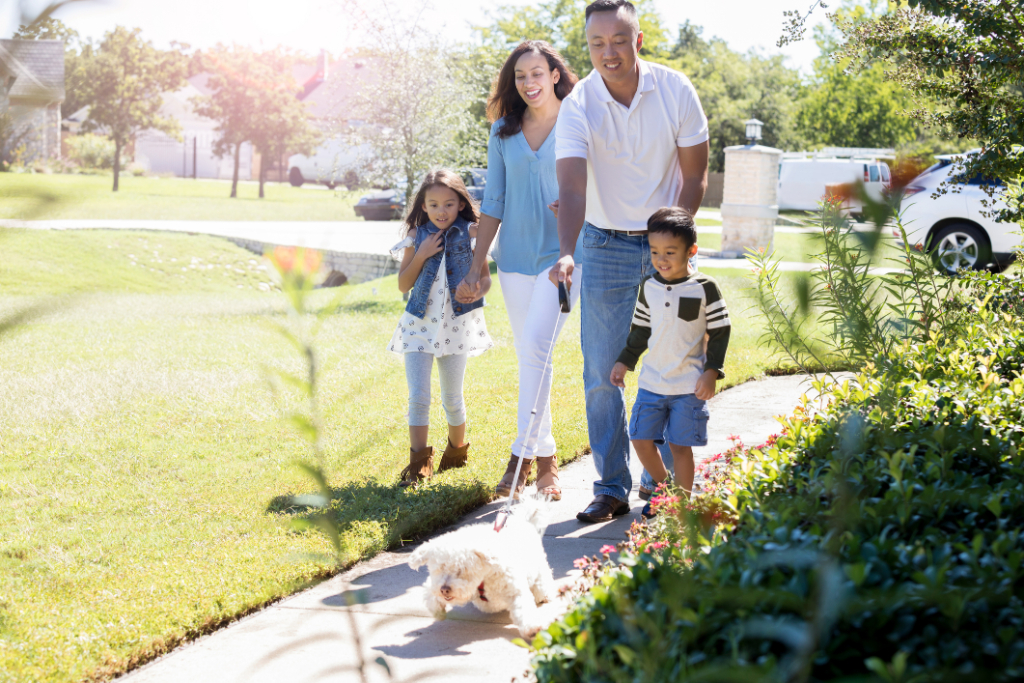 A family walking with their dog