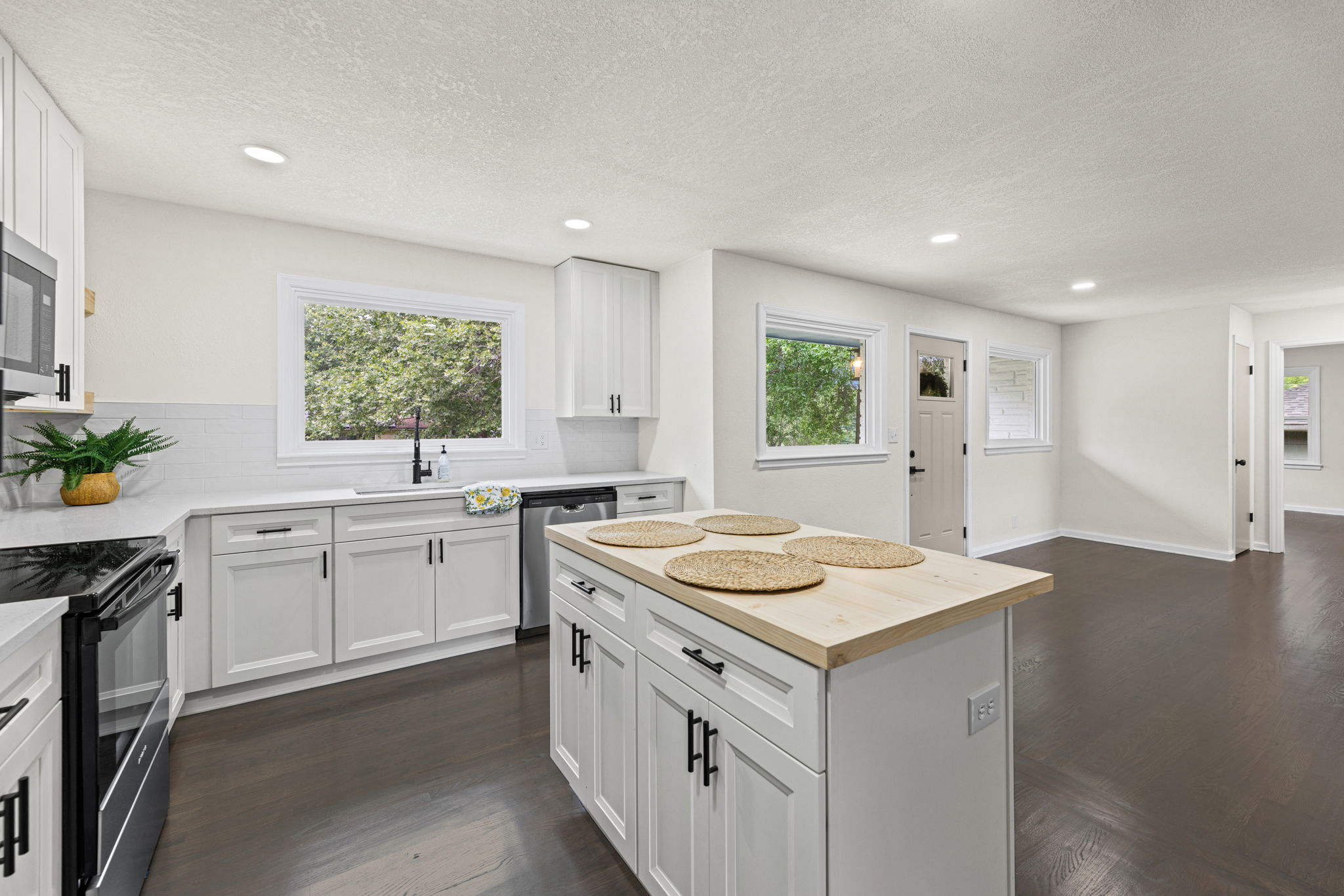 Renovated kitchen in Raytown Missouri home featuring island seating and new appliances