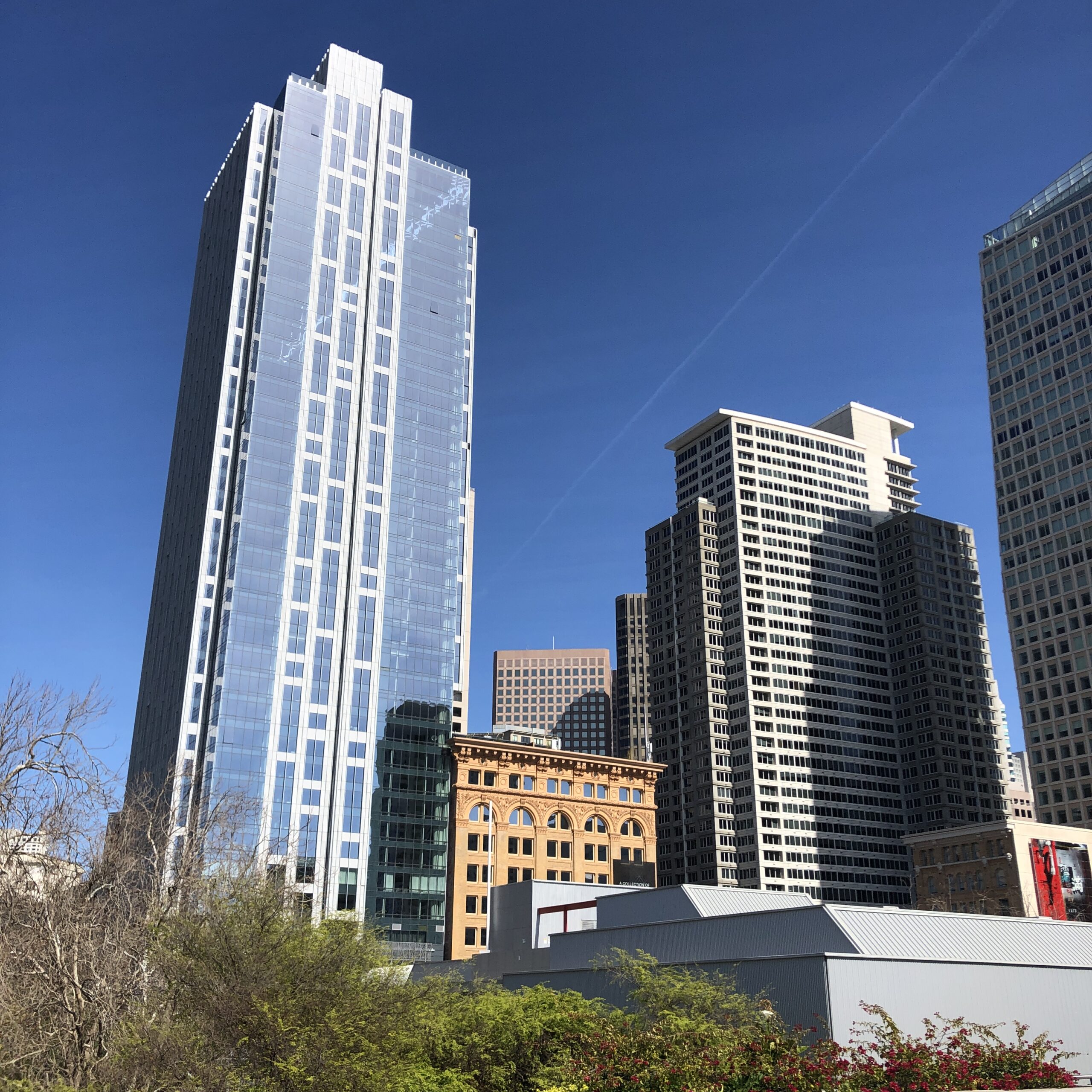 a high rise building next to two mid rise buildings