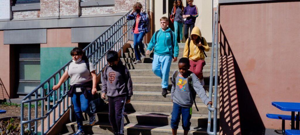 Group of middle school students walking down the stairs at Gateway Middle School