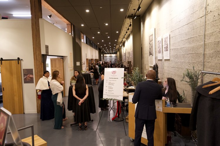 Well-Dressed Parents and Teachers Mingling at the Annual Gala in the hallway of The Dahlia School