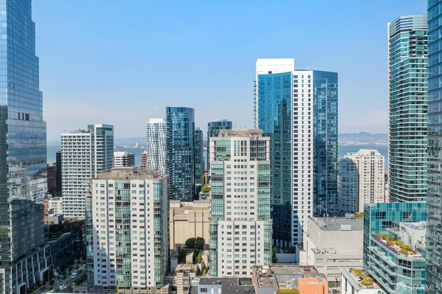 Panoramic view of downtown San Francisco's iconic highrise buildings from a luxury SoMa condo, showcasing the urban lifestyle and prime location