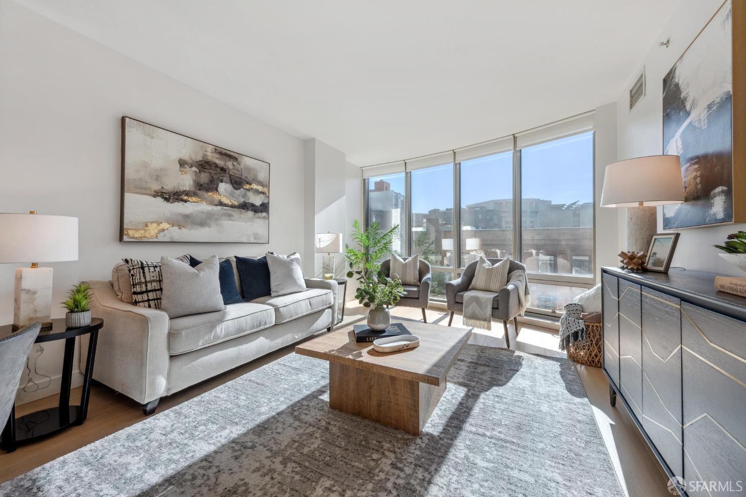 Staged living room in a luxury SoMa condo, featuring modern furniture, large windows, and city views, listed by top San Francisco condo Realtor Robyn Kaufman