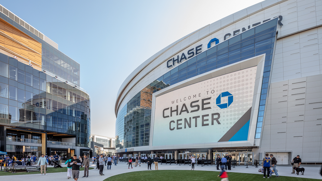 Exterior view of the Chase Center with throngs of people walking and hanging outside