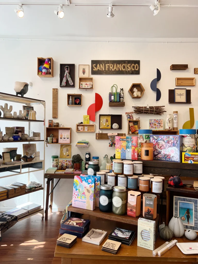 Interior of Therapy Stores in the Mission District with varied collection of artisan goods available for sale including candles, puzzles, artwork, vases, and bags