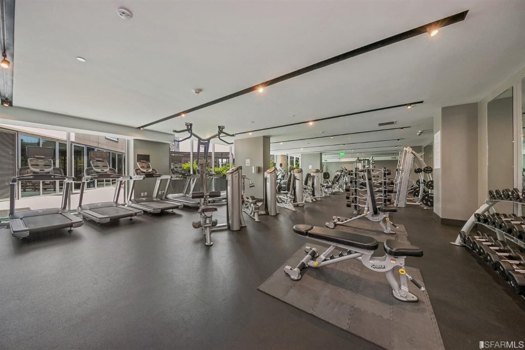 Large gym full of fitness equipment for residents of One Mission Bay condos for sale