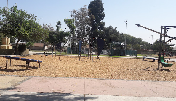 Aerial view of green space, trees, and wide paved walking path with steps at Huntington Park