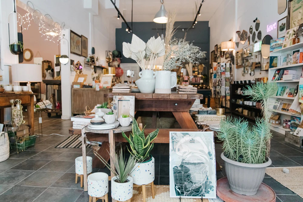 Interior of Picnic SF which contains a variety of home goods including plant pots, wall prints, candles, books, wall mirrors, and picture frames