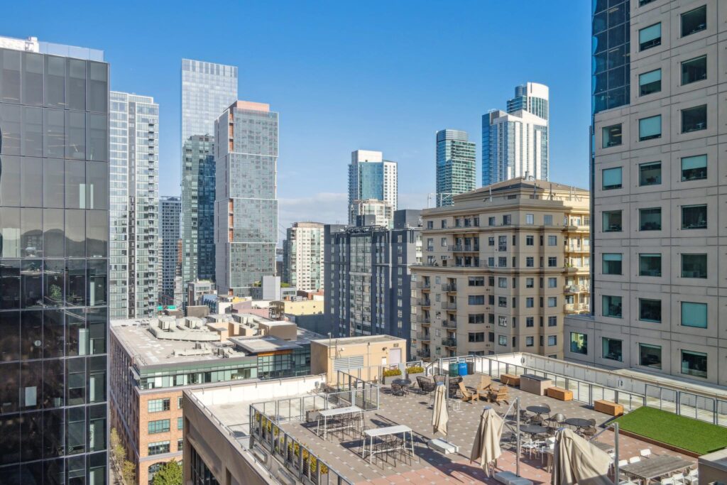View above downtown San Francisco over a rooftop deck, showcasing the amenities of Yerba Buena condo buildings