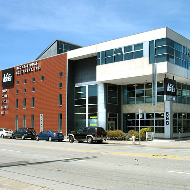 Exterior of large brick and glass building that houses REI (Recreational Equipment, Inc.)