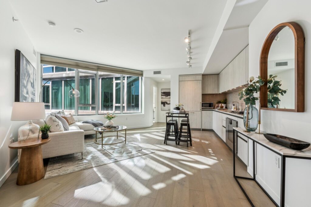 Luxury highrise condo unit at One Mission Bay with light-filled living room and contemporary kitchen