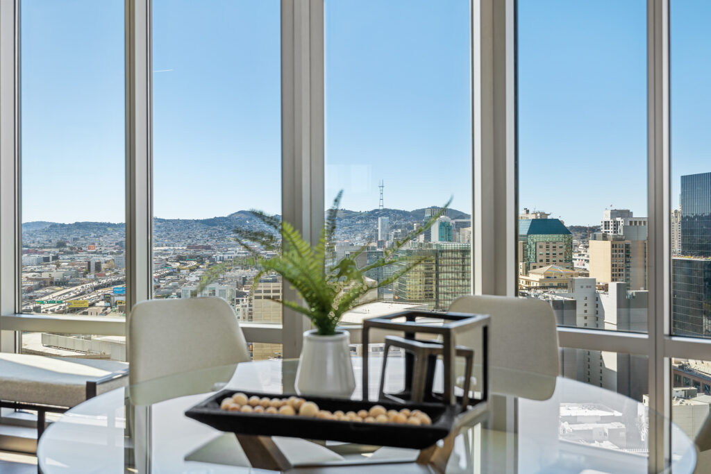 Dining area window in luxury Mission Bay highrise condo, looking out to Twin Peaks San Francisco