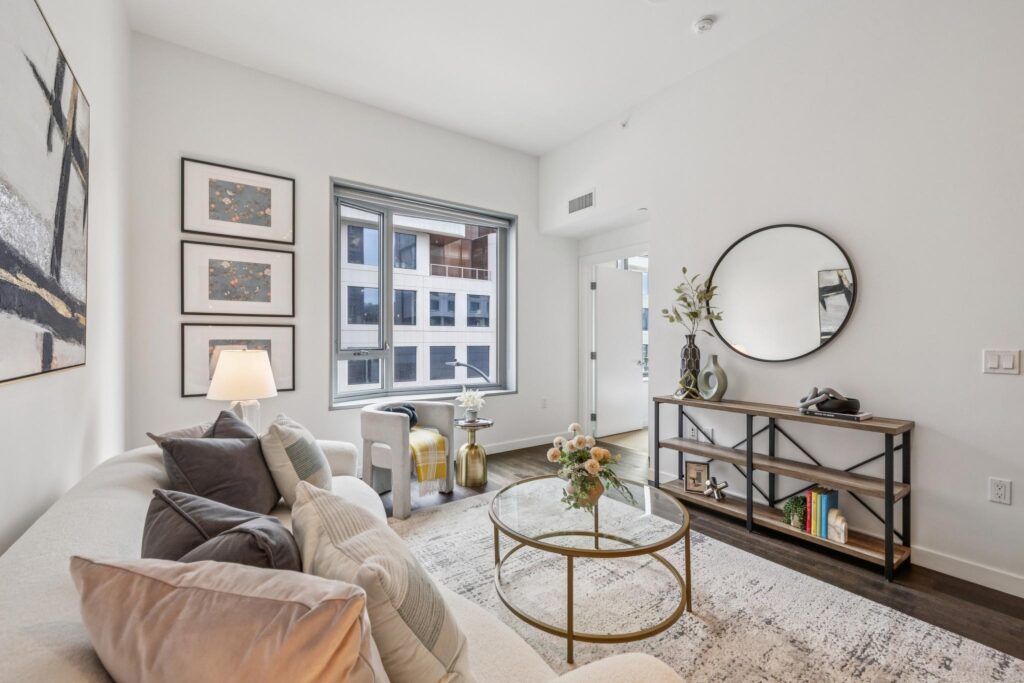 Living room with sofa and chair overlooking Mission Bay SF condos for sale by the top local listing agent