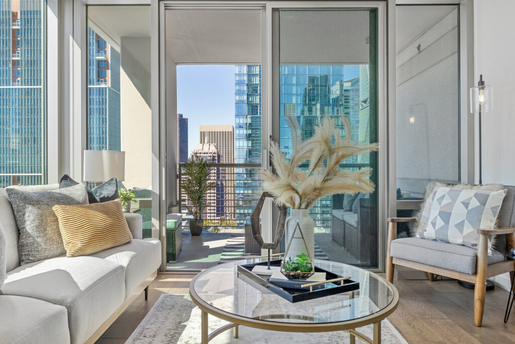 Condo living area with couch, table, and downtown San Francisco views