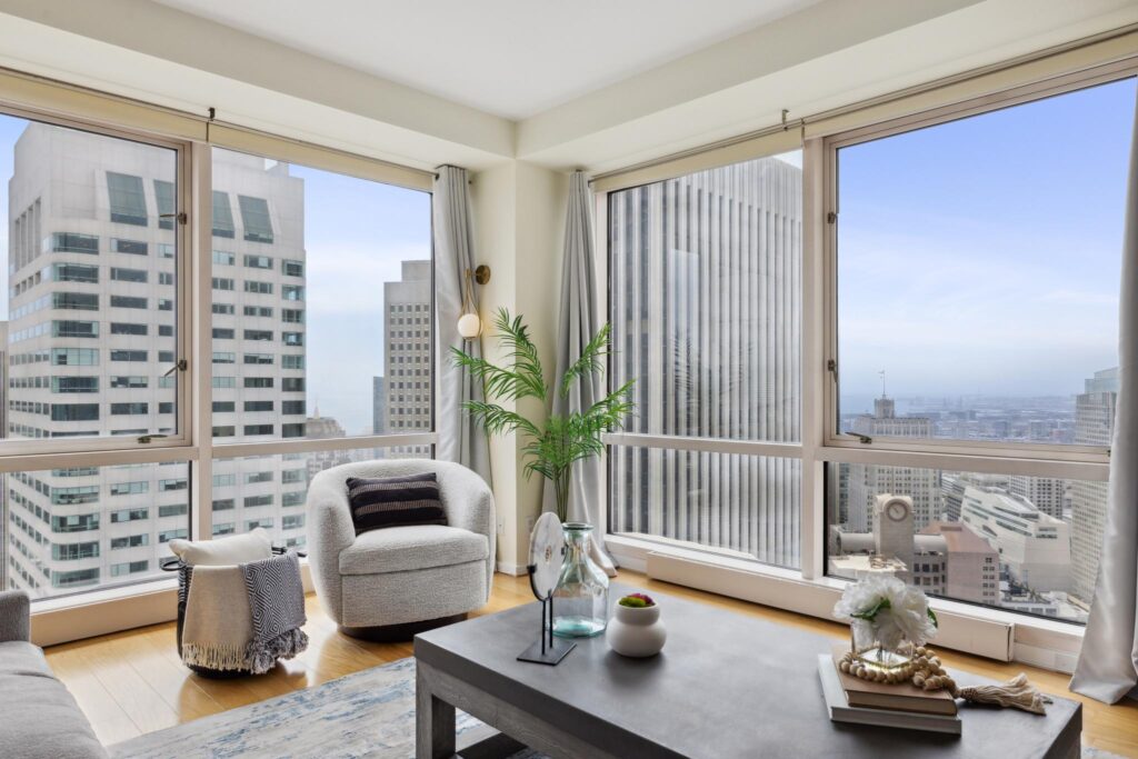 Corner of living room with big highrise condo views of San Francisco, from a listing sold by the best SF condo agent Robyn Kaufman