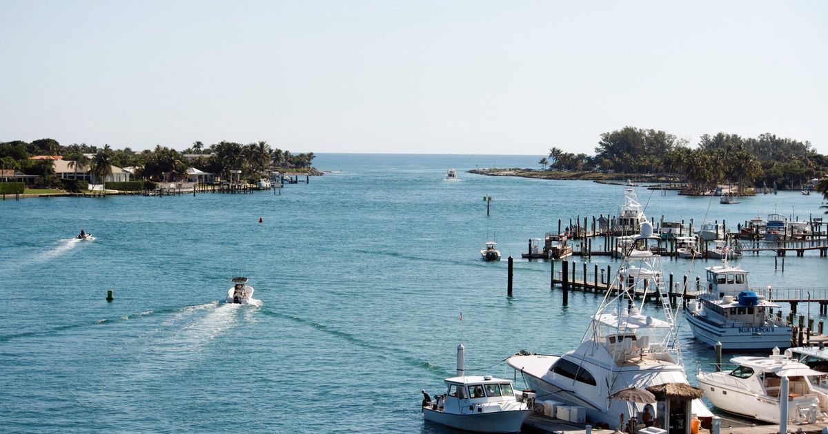 Yachts moored at the Jupiter Inlet in Florida at golden hour, reflecting the area's waterfront luxury