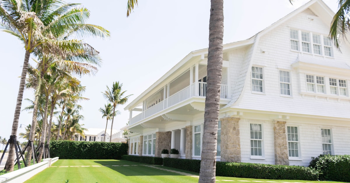 Waterfront home with palm trees in coastal Palm Beach County, Florida