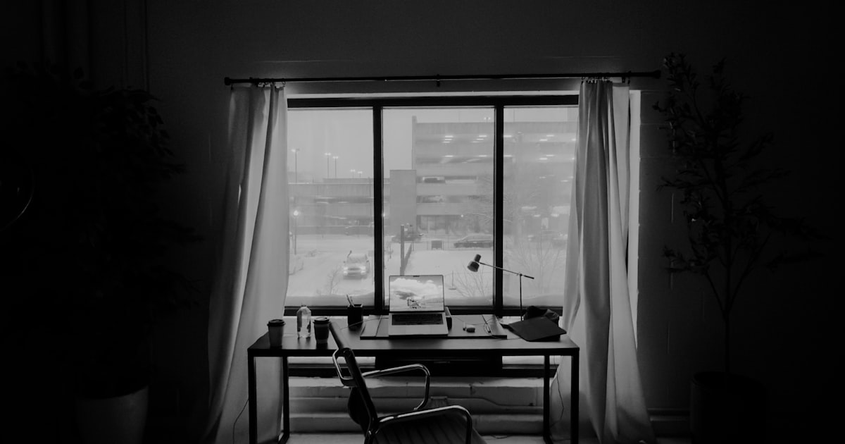 A tidy home office desk beside a sunny window, illustrating remote work among Palm Beach County buyers
