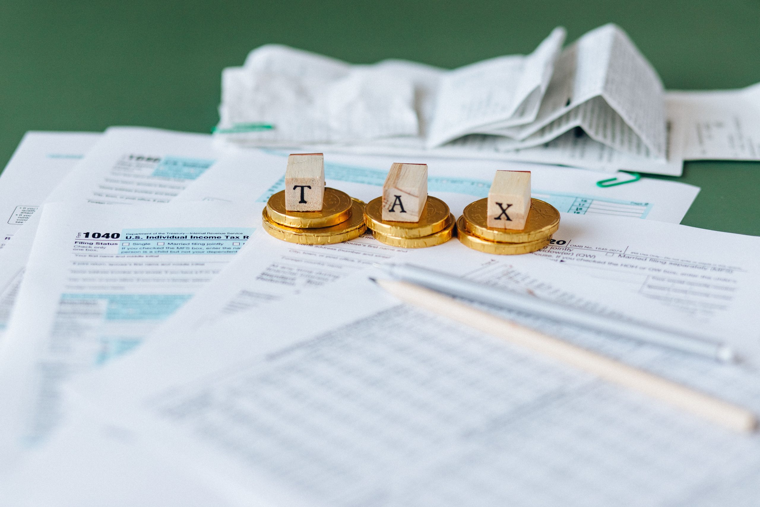 Close-up of financial statements, receipts, and coins on a desk, representing a review of HOA reserves and budgets