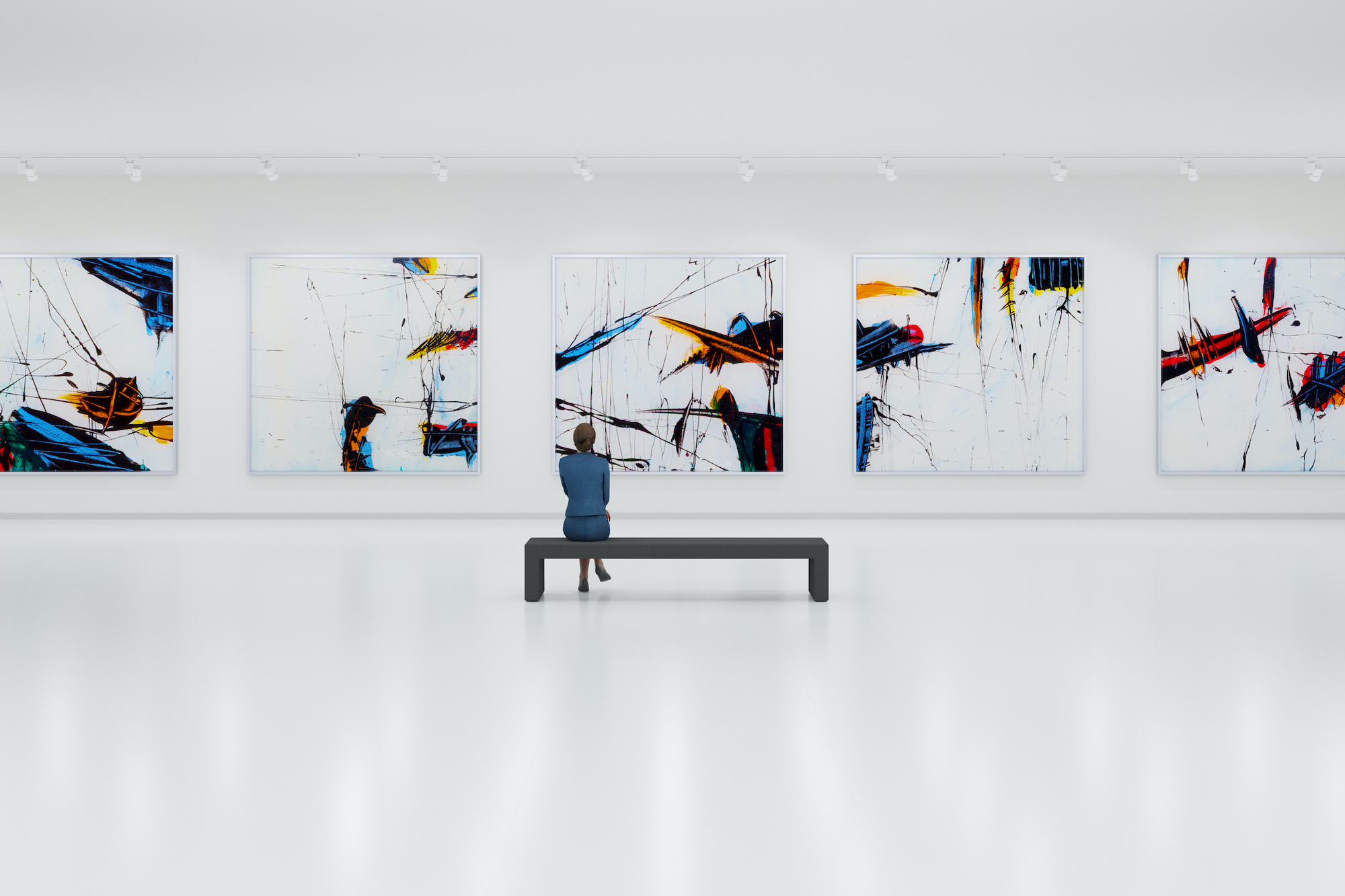The interior of a modern and minimalist art gallery. The floors and walls are white, with large abstract expressionist paintings in black, blue, yellow, and red hanging on the white walls. A visitor looking at the paintings.