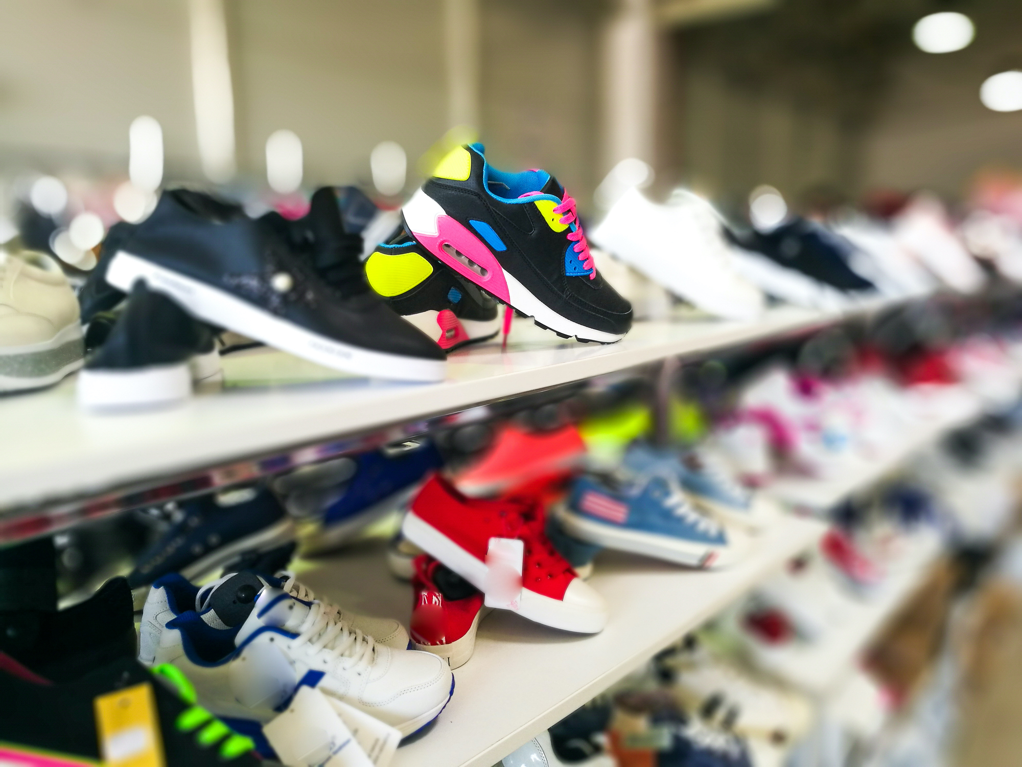 Selection of fashionable sneakers on display in shoe store