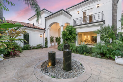 Elegant Home Exterior with Lush Garden Fountain