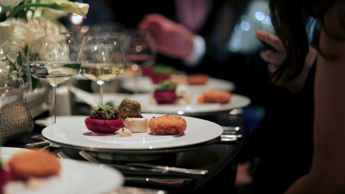 Elegant Fine Dining Experience at a Luxury Event. A beautifully plated dinner set on a luxurious table