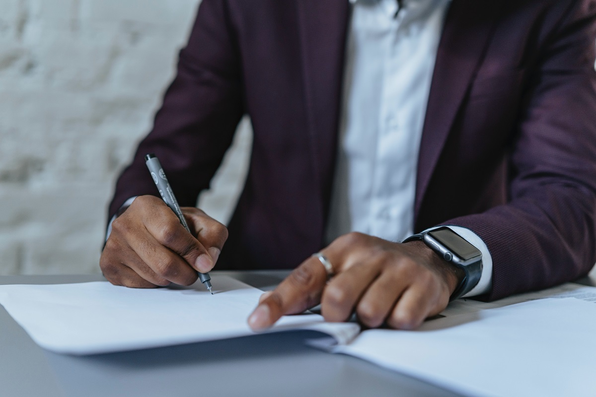 A man signing a letter.