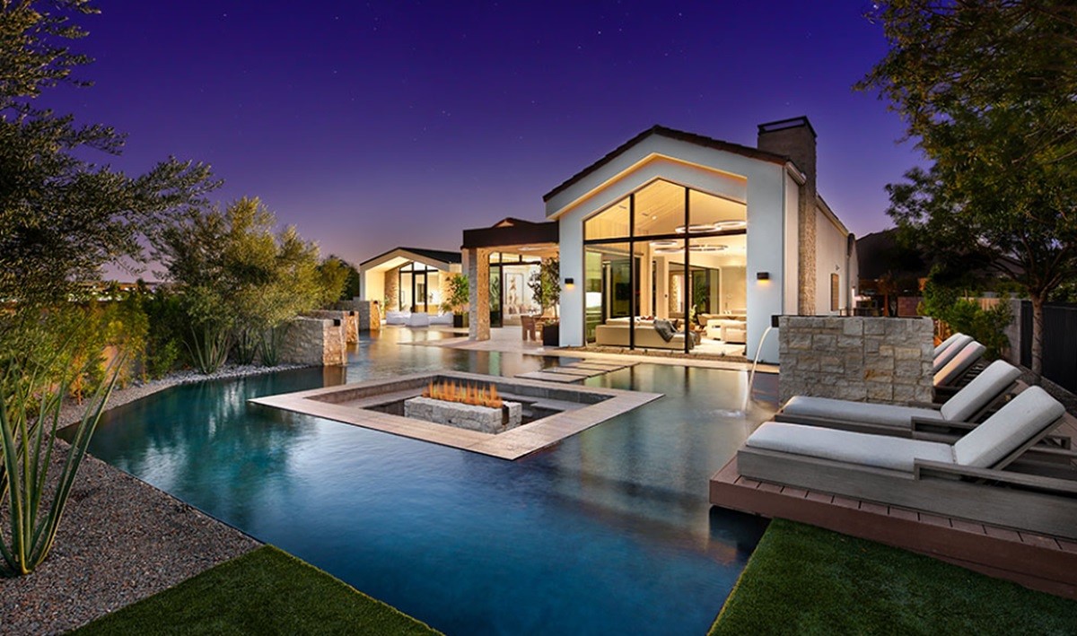 Luxury home in the Azure community with modern architecture, glass walls, a resort-style pool, and sunken fire pit.