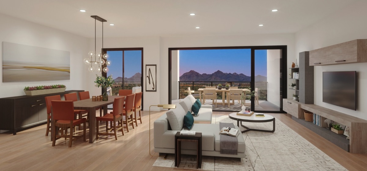 A rendering of a Portico condo interior showcasing an open-plan living and dining space with a stunning mountain view, a large balcony, and stylish, modern furnishings.