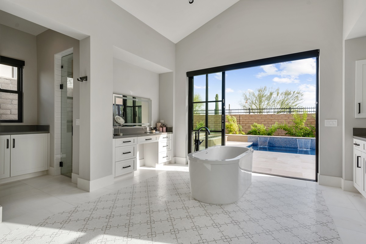 Modern bathroom in White Horse with a freestanding tub, vanity area, and large sliding doors leading to an outdoor pool.

Image 2 (White Horse Pool Area): Evening view of an illuminated outdoor pool in White Horse, with lounge chairs, a covered patio area, and seating, set against a twilight sky.

Let me know if these are good or if you'd like more edits!